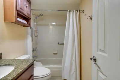 a bathroom with a toilet and a sink and a shower at Englewood Apt with Patio in Denver Tech Center in Englewood