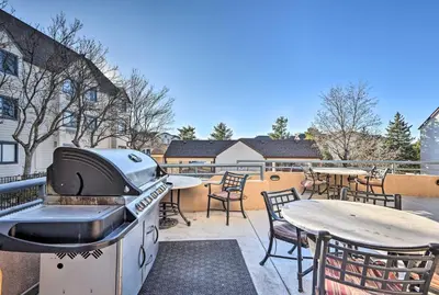 a grill on a patio with tables and chairs at Englewood Apt with Patio in Denver Tech Center in Englewood