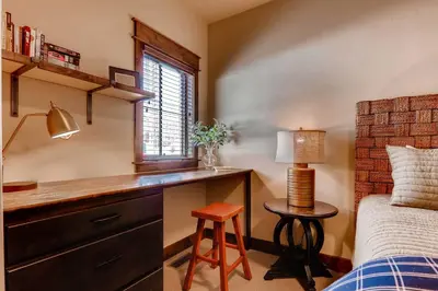 a bedroom with a desk and a bed and a window at Dog-Friendly Cabin in the Heart of Grand Lake! in Grand Lake