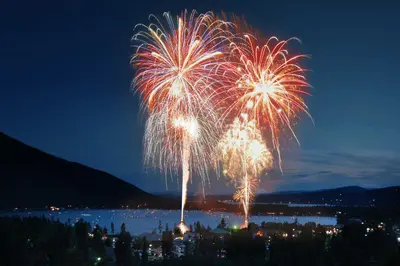 a firework display in the sky over a city at Dog-Friendly Cabin in the Heart of Grand Lake! in Grand Lake