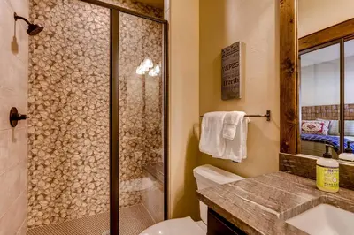 a bathroom with a shower and a toilet and a sink at Dog-Friendly Cabin in the Heart of Grand Lake! in Grand Lake