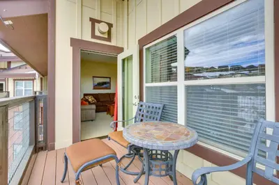 a balcony with a table and chairs and a table at Steps to Ski Lifts Base Camp One Resort Condo in Granby
