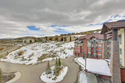 an apartment building with snow on the ground at Steps to Ski Lifts Base Camp One Resort Condo in Granby
