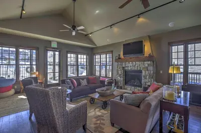 a living room with a couch and a fireplace at Steps to Ski Lifts Base Camp One Resort Condo in Granby