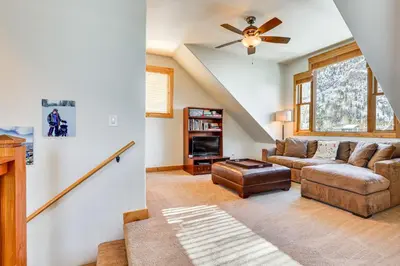 a living room with a couch and a ceiling fan at Dtwn Frisco Home with Mtn View, 11 Mi to Ski Breck! in Frisco