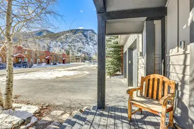 a wooden bench sitting on the side of a building at Dtwn Frisco Home with Mtn View, 11 Mi to Ski Breck! in Frisco