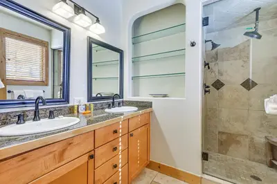 a bathroom with two sinks and a shower at Dtwn Frisco Home with Mtn View, 11 Mi to Ski Breck! in Frisco