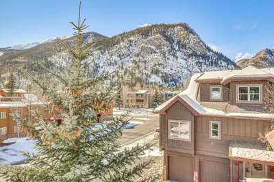 a house with a christmas tree in front of a mountain at Dtwn Frisco Home with Mtn View, 11 Mi to Ski Breck! in Frisco