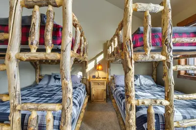 a bedroom with four bunk beds in a cabin at Colorado Escape with Mtn Views! 3 Mi to Winter Park in Fraser