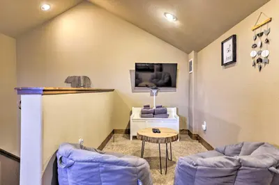 a living room with two chairs and a table at Colorado Escape with Mtn Views! 3 Mi to Winter Park in Fraser
