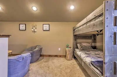 a bedroom with a bunk bed and two chairs at Colorado Escape with Mtn Views! 3 Mi to Winter Park in Fraser