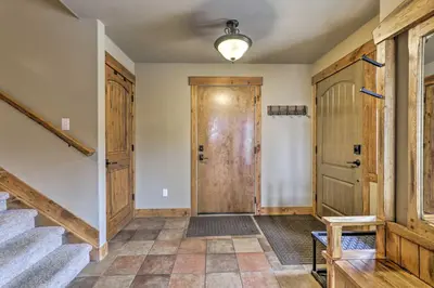 a hallway with stairs and a wooden door at Colorado Escape with Mtn Views! 3 Mi to Winter Park in Fraser