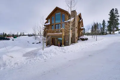 a log cabin in the snow with a driveway at Colorado Escape with Mtn Views! 3 Mi to Winter Park in Fraser