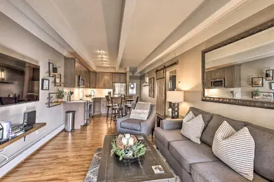 a living room with a couch and a table at Steps to Ski Shuttle! Frisco Condo with Indoor Pool in Frisco