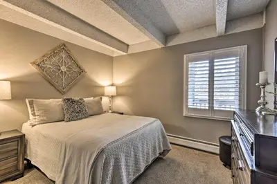 a bedroom with a bed and a window at Steps to Ski Shuttle! Frisco Condo with Indoor Pool in Frisco
