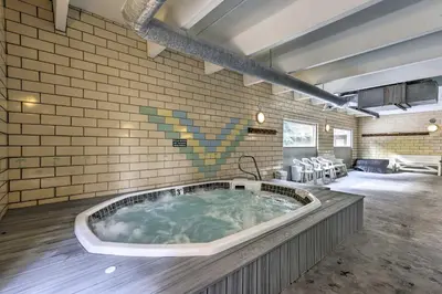a large bath tub in the middle of a room at Steps to Ski Shuttle! Frisco Condo with Indoor Pool in Frisco