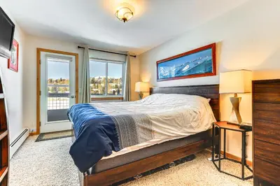 a bedroom with a bed and a large window at Dillon Reservoir On-Site Central and Scenic Condo! in Dillon