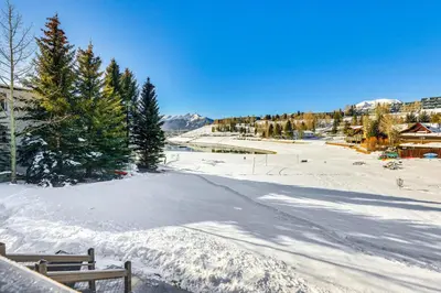 a snow covered street with trees and a river at Dillon Reservoir On-Site Central and Scenic Condo! in Dillon