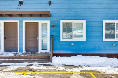 a blue house with a blue door and windows at Dillon Reservoir On-Site Central and Scenic Condo! in Dillon