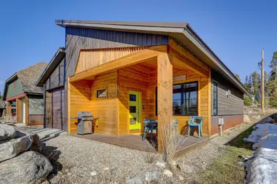 a wooden cabin with a deck with a grill at Fireplace and Deck Modern Cabin in Grand Lake! in Grand Lake