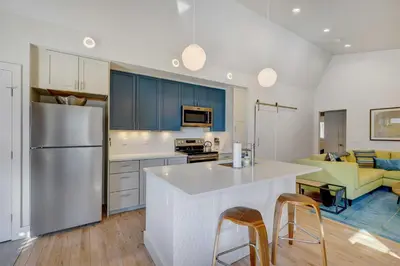 a kitchen with blue cabinets and a white counter top at Fireplace and Deck Modern Cabin in Grand Lake! in Grand Lake