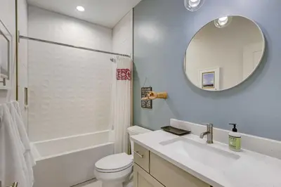 a bathroom with a toilet and a sink and a mirror at Fireplace and Deck Modern Cabin in Grand Lake! in Grand Lake
