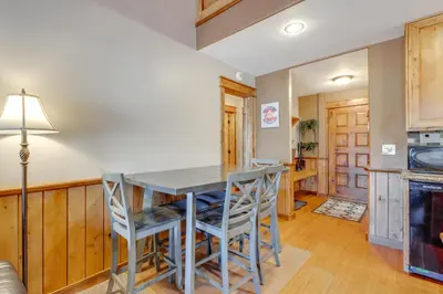 a kitchen with a table and chairs and a stove at The Inn at Silver Creek Resort Retreat with Balcony! in Granby