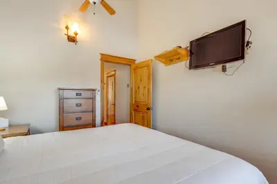 a bedroom with a bed and a flat screen tv at The Inn at Silver Creek Resort Retreat with Balcony! in Granby