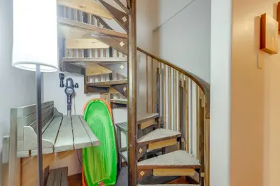a staircase with a green surfboard in a room at The Inn at Silver Creek Resort Retreat with Balcony! in Granby