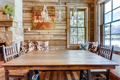 a dining room with a wooden table and chairs at 2 Blocks To Grand Lake Downtown Western Cabin! in Grand Lake