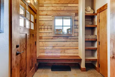 a wooden hallway with a door and a window at 2 Blocks To Grand Lake Downtown Western Cabin! in Grand Lake