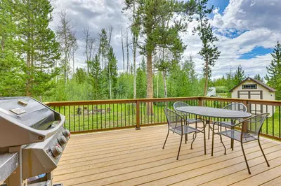 a patio with a table and chairs on a deck at Access to Rocky Mtn Natl Park Grand Lake Cabin in Grand Lake