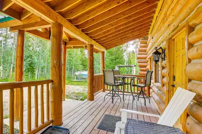 a porch of a cabin with a table and chairs at Access to Rocky Mtn Natl Park Grand Lake Cabin in Grand Lake