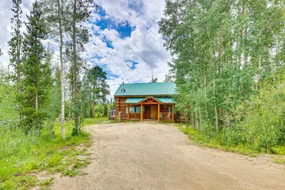 a cabin in the woods with a dirt road in front at Access to Rocky Mtn Natl Park Grand Lake Cabin in Grand Lake