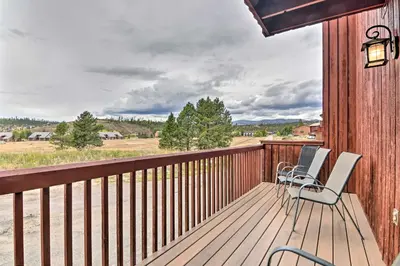 a deck with chairs and a view of a field at Near Lake Granby Grand Lake Townhome with Views in Grand Lake