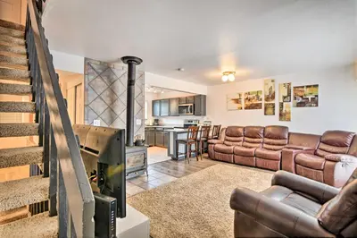 a living room with leather furniture and a fireplace at Near Lake Granby Grand Lake Townhome with Views in Grand Lake