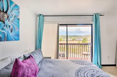 a bedroom with a bed and a view of a balcony at Near Lake Granby Grand Lake Townhome with Views in Grand Lake