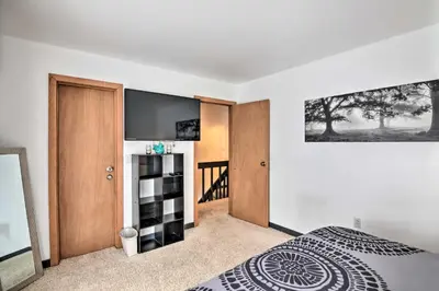 a bedroom with a bed and a tv on a wall at Near Lake Granby Grand Lake Townhome with Views in Grand Lake