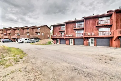 an empty parking lot in front of a building at Near Lake Granby Grand Lake Townhome with Views in Grand Lake