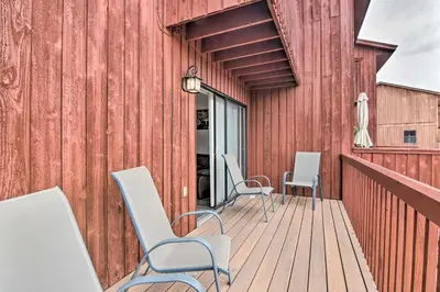 a wooden deck with chairs and a building at Near Lake Granby Grand Lake Townhome with Views in Grand Lake