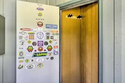 a refrigerator door with stickers on it in a hallway at Winter Park Studio Condo - 5 Mins to Downtown! in Winter Park
