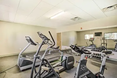 a gym with treadmills and ellipticals in a room at Winter Park Studio Condo - 5 Mins to Downtown! in Winter Park
