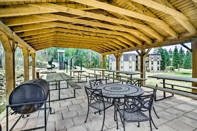 a patio with tables and chairs and a grill at Winter Park Studio Condo - 5 Mins to Downtown! in Winter Park