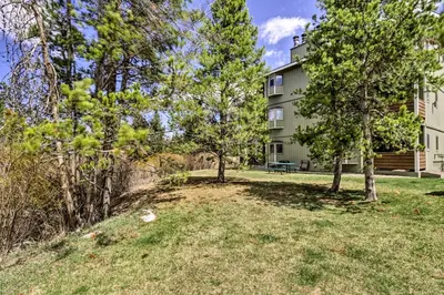 a building with trees in front of it at Winter Park Studio Condo - 5 Mins to Downtown! in Winter Park