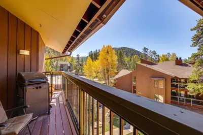 a balcony with a grill and a view of the mountains at Ski Shuttle and Mountain Views Keystone Resort Home in Keystone