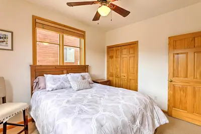 a bedroom with a bed and a ceiling fan at 7 Mi to National Park Grand Lake Condo with Deck! in Grand Lake