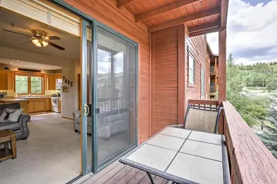 a screened porch with a chair on a deck at 7 Mi to National Park Grand Lake Condo with Deck! in Grand Lake