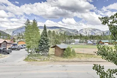 a parking lot in a town with mountains in the background at 7 Mi to National Park Grand Lake Condo with Deck! in Grand Lake