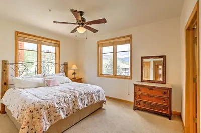 a bedroom with a bed and a ceiling fan at 7 Mi to National Park Grand Lake Condo with Deck! in Grand Lake