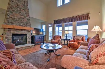a living room with couches and a fireplace at 1 Mi to Granby Ranch Mtn Home with Deck in Granby